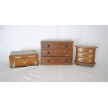 An antique oak miniature chest of three drawers along with a rosewood jewellery box and one other