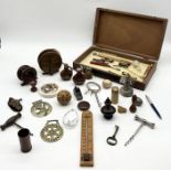 An assortment of various items including fishing reels, keys, ACME whistle, horse brasses etc.