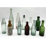 A collection of antique glass bottles including two L. Rose & Co lemonade bottles, Frank Browne,