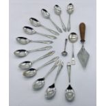 A set of twelve hallmarked silver coffee spoons along with a small wooden handled silver trowel