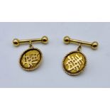 A pair of Chinese 20ct gold cufflinks with Chinese characters, total weight 6.9g