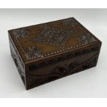 A carved wooden box lined in blue velvet