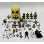 A collection of Star Wars toys including three figurines (Darth Vader, Stormtrooper, Luke