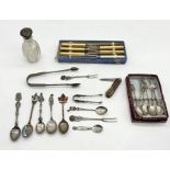 A collection of SCM spoons, boxed knives, silver topped shaker, silver sugar tongs etc.