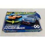 A boxed Scalextric Porsche Power-Slide set (1:32 scale), along with three additional cars