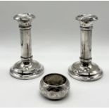 A pair of hallmarked silver candlesticks (12cm height) along with a silver napkin ring