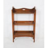 A small oak freestanding bookcase, marked 'Matthews Limited Furnishers, Gloucester' - length 54cm,