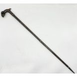 A vintage Islamic walking stick with rams head handle and niello work detail