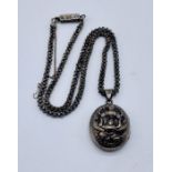 An Indian silver locket depicting Deities on fancy silver chain