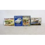 A collection of four retro enamel signs depicting Morris Minor, Navy & Army Illustrated, Dunlop