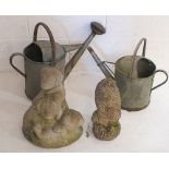Two galvanised watering cans plus two reconstituted stone garden ornaments, one in the form of a