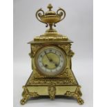 A French style gilt metal mantle clock with top acorn finial, lions head handles and enamelled