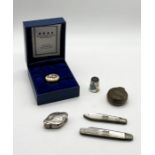 A small 925 silver pill box along with two silver bladed fruit knives, sovereign case, enamelled