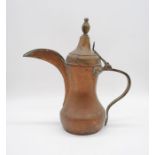 An Eastern copper coffee pot - height 37cm