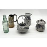 Three pieces of studio pottery by Andrew Hague along with a horn cup and Warminster glass bottle
