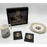 A glass cased and mounted brass bust of Wellington along with a Lord Nelson pottery plate, The