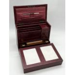 A leather cased travelling stationary cabinet with fold out writing slope, inkwells etc. Pencil