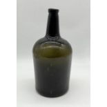 A large 18th century green glass bottle - height 34cm