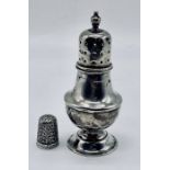 A small hallmarked silver pepperette along with a silver thimble