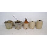 A pair of reconstituted stone garden pots along with three stoneware jars