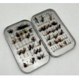 A Hardy Bros fly tin containing a selection of fishing flies.