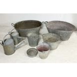 A collection of various galvanised items including two baths, buckets, watering cans etc.