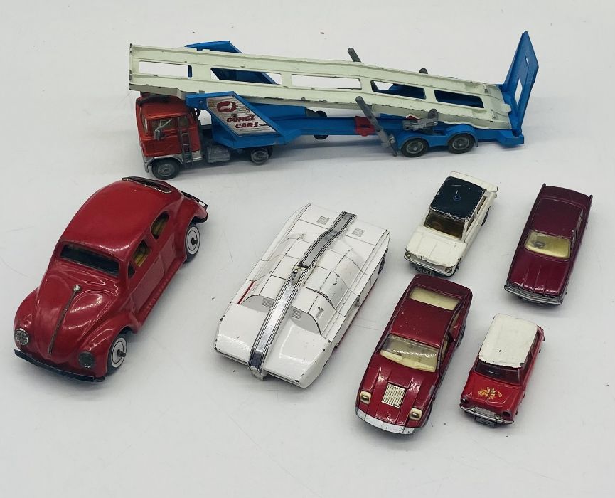A small collection of play worn die-cast vehicles including a Corgi carrimore car transporter, Dinky