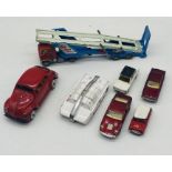 A small collection of play worn die-cast vehicles including a Corgi carrimore car transporter, Dinky