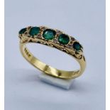 An 18ct gold emerald 5 stone with diamond infills, total weight 3.5g