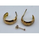 A pair of 9ct gold (tested) hoop earrings along with a single earring total weight 1.7g