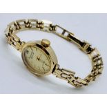 A ladies Accurist Diamond 9ct gold wristwatch set with a diamond to the 12 position on 9ct gold