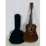 An Antoria 6 string acoustic guitar (Model number SF124) with soft carry case