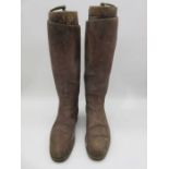 A pair of antique riding boots with boot trees