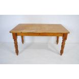 A pine farmhouse table with single drawer, raised on turned legs - length 152cm, depth 90cm,