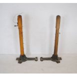 A pair of antique Slazenger's tennis posts with cast iron bases