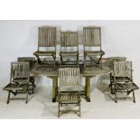 A weathered Neptune Classics wooden garden table, along with eight matching folding chairs (