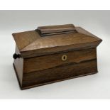 A 19th century sarcophagus shaped rosewood tea caddy with glass mixing bowl and two interior boxes