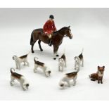 A Beswick mounted huntsman with six hounds (two repaired as shown) and seated fox