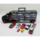 An Asda storage toy carry case in the form of a lorry with various die-cast vehicles enclosed, along