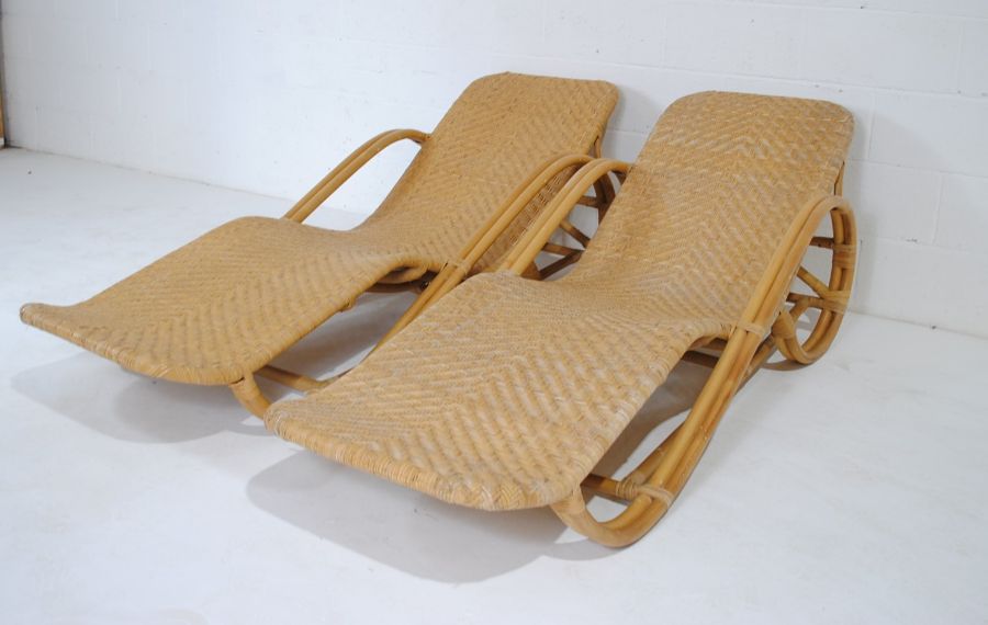 A pair of bamboo and rattan sun loungers