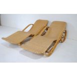 A pair of bamboo and rattan sun loungers