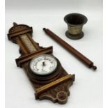 A carved wooden aneroid barometer along with a brass mortar etc.