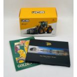 A boxed JCB 435S Stage V Wheel loader die-cast model, along with two JCB books
