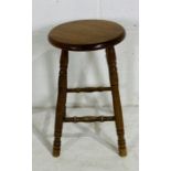 A wooden stool on turned legs.