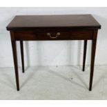 A Georgian mahogany tea table with inlaid decoration on tapering legs.