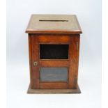 A turn of the century oak letter box - one glass panel missing - length 25.5cm, depth 19.5cm, height