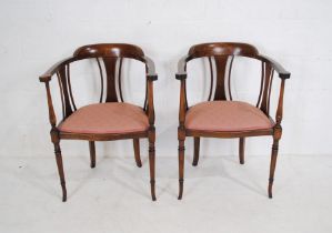 A pair of Edwardian inlaid mahogany tub chairs, marked 'Jarvis & Bulman Ltd' of Cardiff