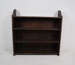 A stained pine freestanding bookcase - length 91cm, depth 27cm, height 92cm