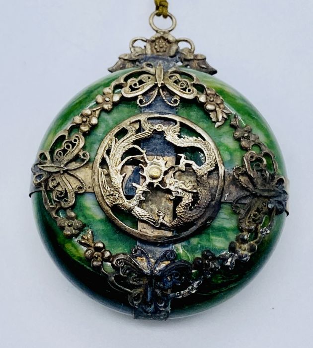 A Japanese green hardstone pendant with SCM decoration of a dragon and pheonix chasing the flaming - Image 2 of 3