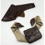 A leather gun holster and cartridge case on belt